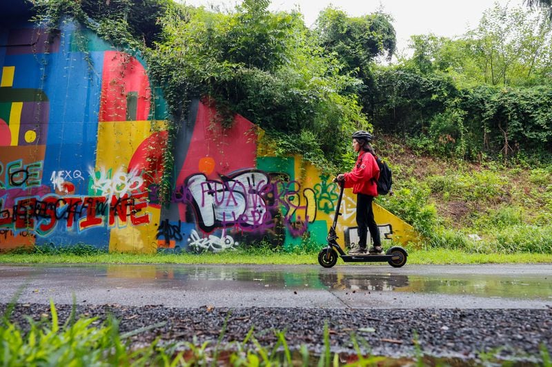 Mona Su rides her scooter along the Atlanta Beltline.