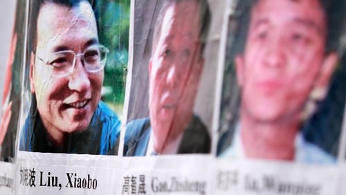 Pictures of Chinese dissidents, including Nobel Prize laureate Liu Xiaobo (L), are seen on a banner during a rally for Liu December 10, 2010 in Washington, DC.