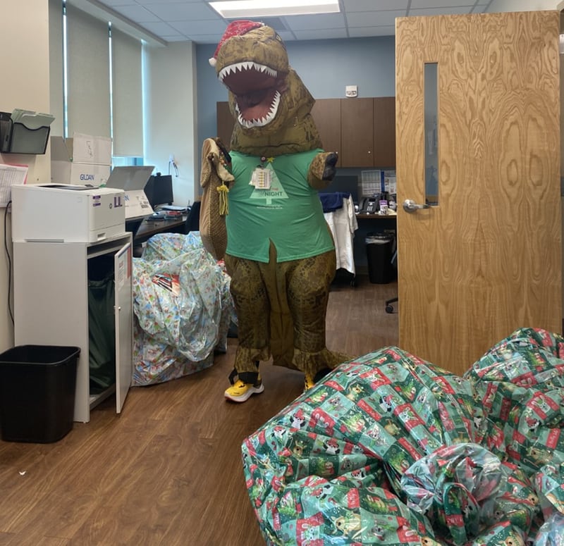 Dino joins staff of the Emergency Department at Wellstar Kennestone Regional Medical Center as they collect gifts as part of a holiday drive in December 2023. Courtesy of Wellstar Kennestone Regional Medical Center
 