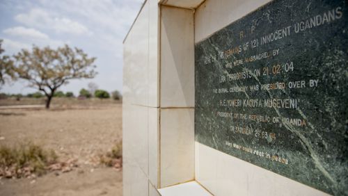 In this file photo taken Thursday, Feb. 12, 2015, a memorial marks the location of a mass burial site of those massacred in 2004 by the Lord's Resistance Army (LRA), at the Barlonyo displaced persons camp in northern Uganda. Eleven years after the LRA attacked Barlonyo, the International Criminal Court in The Hague is preparing to try senior LRA commander Dominic Ongwen for war crimes and crimes against humanity and while Ugandan military officials and survivors say he helped direct the attack on the camp in Barlonyo, some survivors of the Feb. 21, 2004, attack say Ongwen should not be tried by the ICC. (AP Photo/Rebecca Vassie, File)