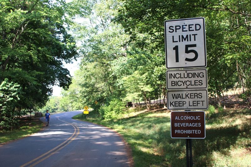 A sign shows the speed limit at 15 miles per hour for bikes and cars as seen on Monday, July 1, 2024. National Park Service staff said some cyclists and motorists go way above the speed limit, creating safety concerns on Kennesaw Mountain road. (Taylor Croft/taylor.croft@ajc.com)