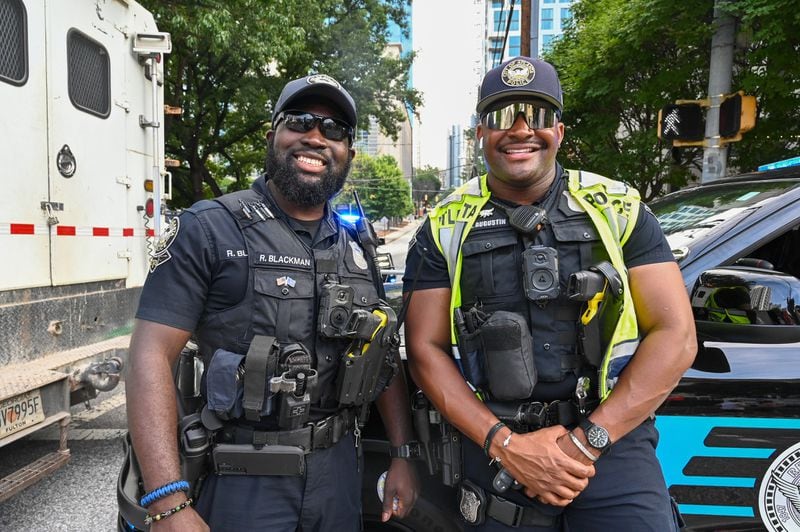 Two Atlanta officers grin for the camera during the 55th annual Peachtree Road Race.