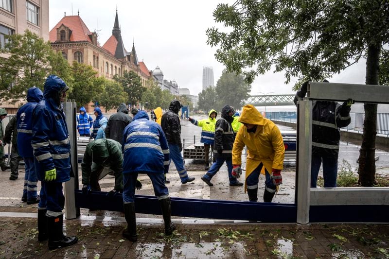 Workers set up rarely-used mobile anti-flood walls at the bank of Danube river in Bratislava, Slovakia, Sunday, Sept. 15, 2024. (AP Photo/Tomas Hrivnak)