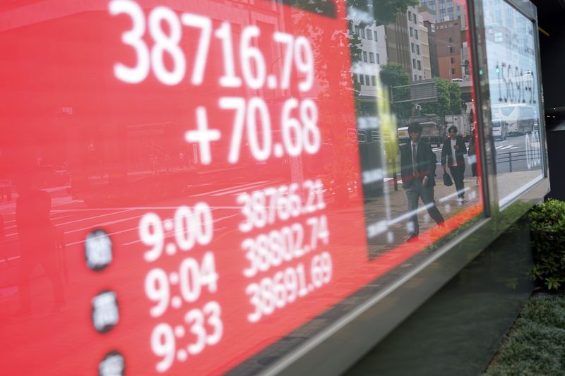 People are reflected on an electronic stock board showing Japan's Nikkei 225 index at a securities firm Monday, May 27, 2024, in Tokyo. (AP Photo/Eugene Hoshiko)