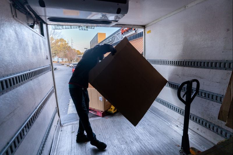 Dexter Samples loads boxes of Thanksgiving day meals onto a truck that will be delivered to people around Atlanta on Thursday, November 23, 2023.  (Steve Schaefer/steve.schaefer@ajc.com)