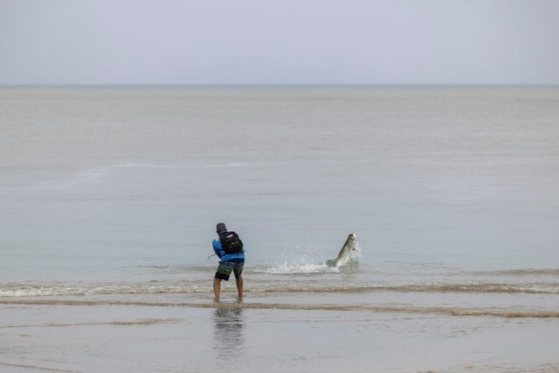 A man fishes after Tropical Storm Ernesto passed through Rio Grande, Puerto Rico, Wednesday, Aug. 14, 2024. (AP Photo/Alejandro Granadillo)