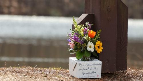 Mourners laid flowers at Lake Herrick in Athens, Georgia, at the University of Georgia on Friday, Feb. 23, 2024. Laken Riley, a 22-year-old nursing student, was found dead nearby on Thursday. (Jason Getz/The Atlanta Journal-Constitution/TNS)