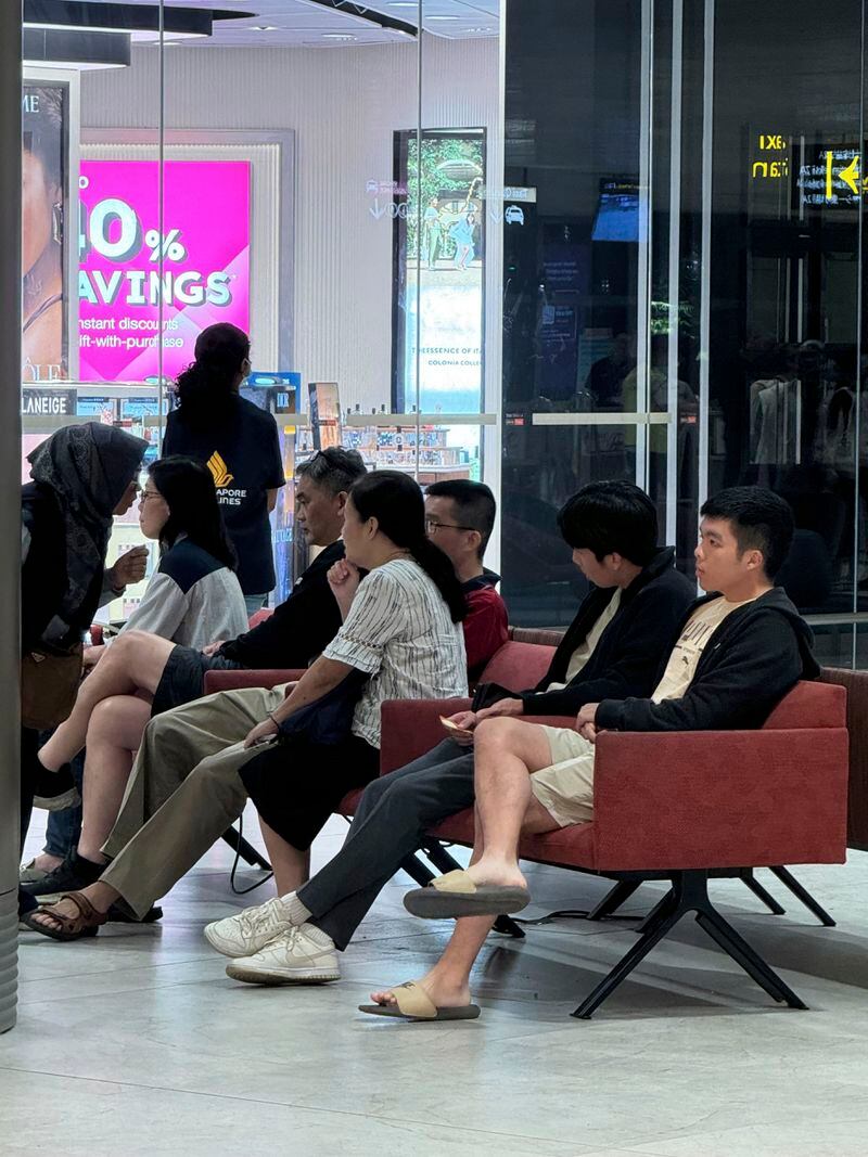 Family members wait for passengers arrival from Bangkok at a Singapore airport Wednesday, May 22, 2024. A Singapore Airlines flight from London's Heathrow airport to Singapore was diverted and landed in stormy weather in Bangkok on Tuesday. (AP Photo)