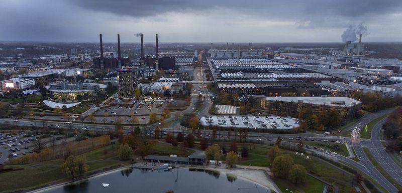 FILE - Smoke rises from a chimney of the Volkswagen car factory in Wolfsburg, Germany, Monday, Nov. 8, 2021. (AP Photo/Michael Sohn, File)