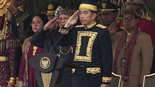 Indonesian President Joko Widodo, center, and Defense Minister and president-elect Prabowo Subianto, second left, salute during the ceremony marking Indonesia's 79th anniversary of independence at the new presidential palace in its future capital of Nusantara, a city still under construction on the island of Borneo, Saturday, Aug. 17, 2024. (AP Photo/Achmad Ibrahim)