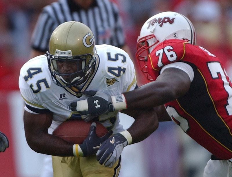 041009 - COLLEGE PARK, MARYLAND -- GA Tech's P.J. DANIELS tries to out run Maryland's HENRY SCOTT at the University of Maryland on SATURDAY, Oct. 9, 2004. Georgia Tech won the game 20 to 7. (JOHNNY CRAWFORD/AJC file)