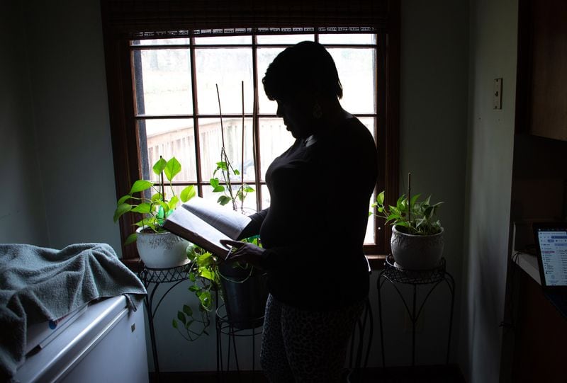 A client of the federal Housing Opportunities for Persons with AIDS program looks out the front door of the Ellenwood house where she was staying on Sunday, December 23, 2021.  She is homeless after her case fell through the cracks of the city of Atlanta-run program.  STEVE SCHAEFER FOR THE ATLANTA JOURNAL-CONSTITUTION STEVE SCHAEFER FOR THE ATLANTA JOURNAL-CONSTITUTION