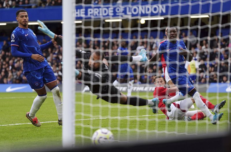 Nottingham Forest's Chris Wood scores their side's first goal of the game during the English Premier League soccer match between Chelsea and Nottingham Forest at Stamford Bridge in London, Sunday Oct. 6, 2024. (Bradley Collyer/PA via AP)