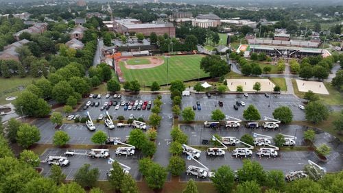 Utility trucks are staged at Mercer University campus parking lot, Thursday, September 26, 2024, in Macon. Hurricane Helene is set to make landfall as a major storm in Florida on Thursday evening, bringing rain and damaging wind to Georgia. Emergency officials are warning of fallen trees, downed power lines, shuttered roads and even the possibility of landslides as Helene makes its way through Georgia overnight. (Hyosub Shin / AJC)