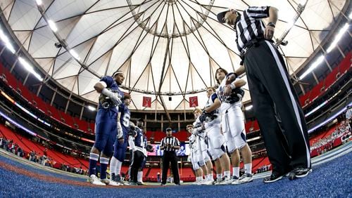 ELCA team members (left) and Fellowship team members participate in the coin toss before their Class A-Private state championship game Friday, Dec. 9, 2016, at the Georgia Dome in Atlanta.