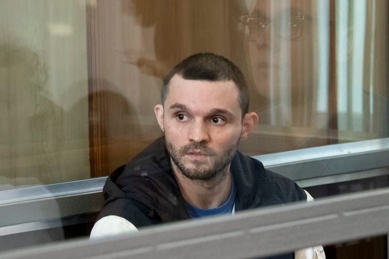 U.S. Army Staff Sgt. Gordon Black sits in a glass cage in a courtroom in Vladivostok, Russia, Wednesday, June 19, 2024. Black is on trial on charges of theft and threatening murder in a dispute with a Russian woman. Russian state media reported that he denied the allegation of threatening murder but "partially" admitted to theft. (AP Photo)