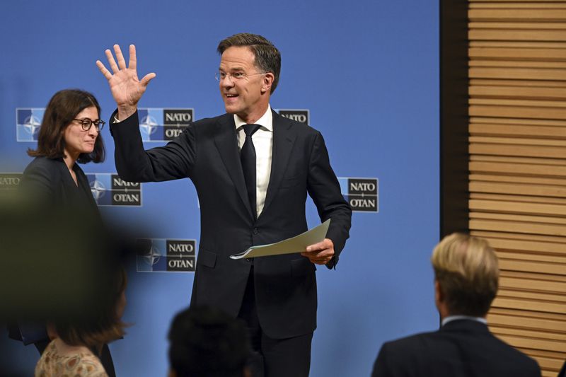 The new NATO Secretary General Mark Rutte waves to the reporters after a press conference at NATO headquarters in Brussels, Belgium, Tuesday, Oct. 1, 2024. (AP Photo/Harry Nakos)