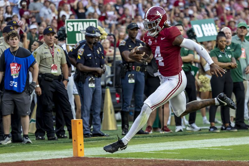 Alabama quarterback Jalen Milroe (4) runs the ball for a touchdown against South Florida during the first half of an NCAA college football game, Saturday, Sept. 7, 2024, in Tuscaloosa, Ala. (AP Photo/Vasha Hunt)