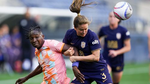 FILE - Orlando Pride forward Barbra Banda, left, goes up for the ball against Seattle Reign defender Lauren Barnes (3) during the first half of an NWSL soccer match, Sunday, May 19, 2024, in Seattle. (AP Photo/Lindsey Wasson, File)