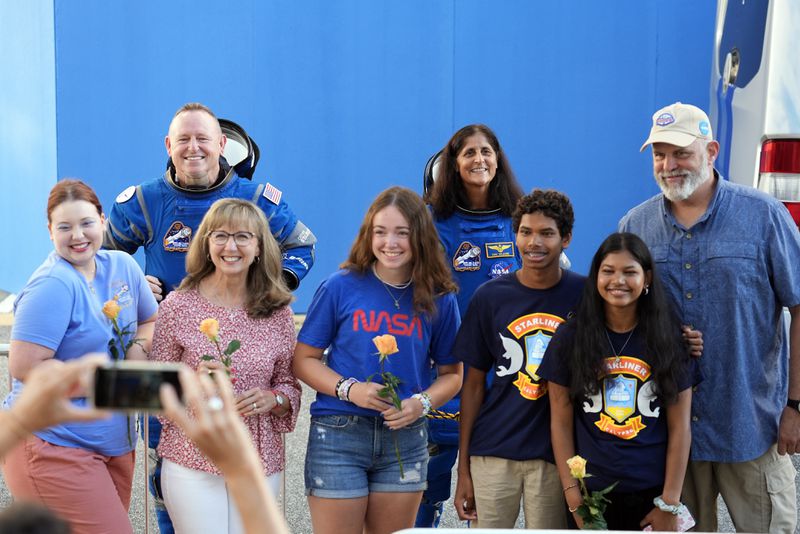 FILE - NASA astronauts Butch Wilmore, background left, and Suni Williams, background right, pose for a photo with their families after leaving the operations and checkout building for a trip to launch pad at Space Launch Complex 41 Wednesday, June 5, 2024, in Cape Canaveral, Fla., before launching on the Boeing Starliner capsule for a trip to the international space station. (AP Photo/Chris O'Meara, File)