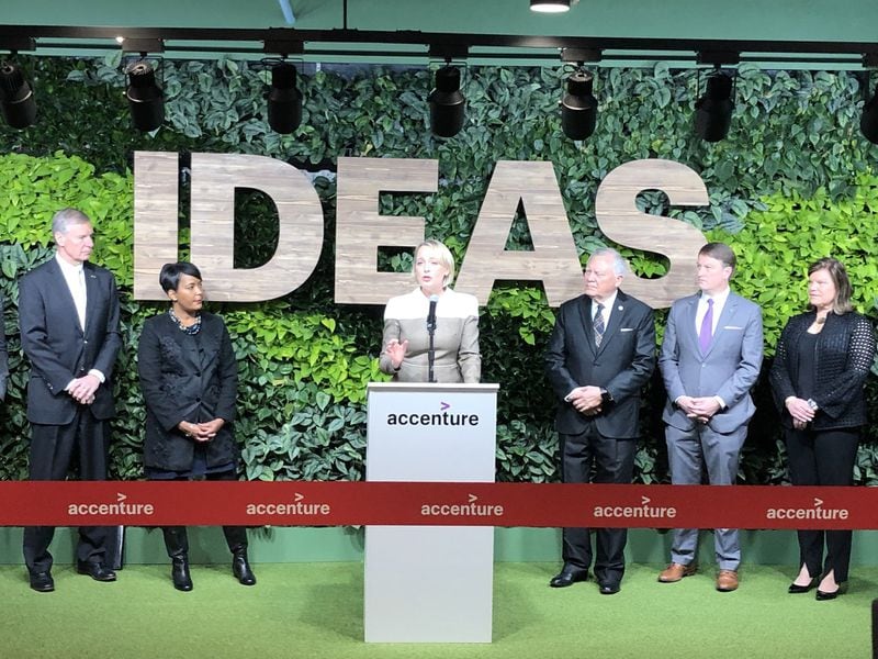 Julie Sweet (center), then the North American CEO for Accenture, speaks Dec. 12, 2018, before a formal ribbon cutting for the global consulting group’s new technology hub at Technology Square in Midtown. Today, Sweet is the CEO of the global consulting firm. Standing from left to right were then-Georgia Tech President Bud Peterson, then-Atlanta Mayor Keisha Lance Bottoms, then- Gov. Nathan Deal and state Department of Economic Development Commissioner Pat Wilson. J. SCOTT TRUBEY/AJC