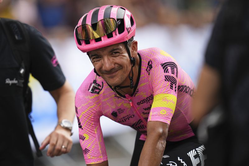 Ecuador's Richard Carapaz is all smiles after crossing the finish line knowing he took the overall leader's yellow jersey by finishing with the sprinters in the third stage of the Tour de France cycling race over 230.8 kilometers (143.4 miles) with start in Piacenza and finish in Turin, Italy, Monday, July 1, 2024. (AP Photo/Daniel Cole)