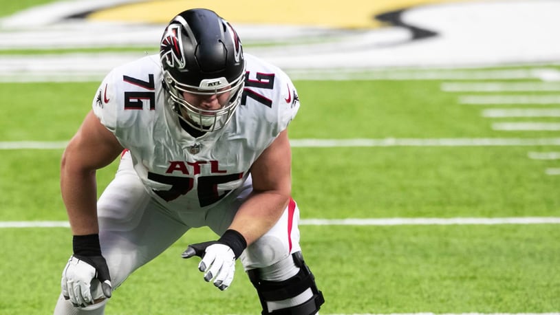 Atlanta Falcons offensive tackle Kaleb McGary (76), left, works against an  unidentifed teammate during the first day of team's NFL football training  camp pratice Wednesday, July 26, 2023, in Flowery Branch, Ga. (