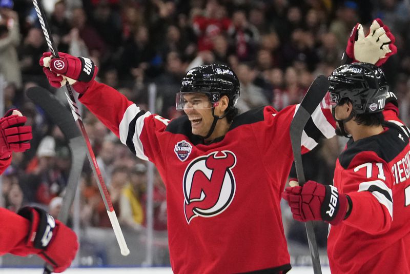 New Jersey Devils' Johnathan Kovacevic, centre, celebrates after scoring his side's second goal during the NHL hockey game between Buffalo Sabres and New Jersey Devils, in Prague, Czech Republic, Friday, Oct. 4, 2024. (AP Photo/Petr David Josek)