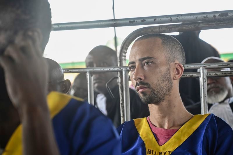 Benjamin Reuben Zalman-Polun sits in court in Kinshasa with 52 other defendants Friday June 7, 2024, accused of a role in last month's attempted coup in Congo led by little-known opposition figure Christian Malanga in which six people were killed. (AP Photo/Samy Ntumba Shambuyi)