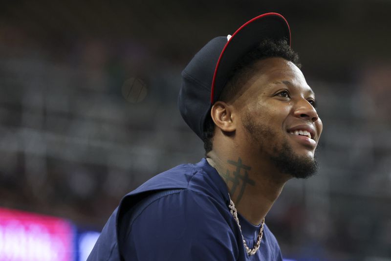 Atlanta Braves injured outfielder Ronald Acuña Jr. talks with teammates during the eighth inning against the New York Mets at Truist Park, Tuesday, Sept. 24, 2024, in Atlanta. (Jason Getz / AJC)

