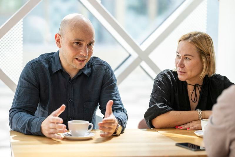 Andrei Pivovarov, a Russian dissident freed in the historic East-West prison swap on Aug. 1, left, and his wife, Tatyana Usmanova, speak during an interview with The Associated Press in Berlin, Germany, on Sunday, Aug. 12, 2024. (AP Photo/Axel Schmidt)