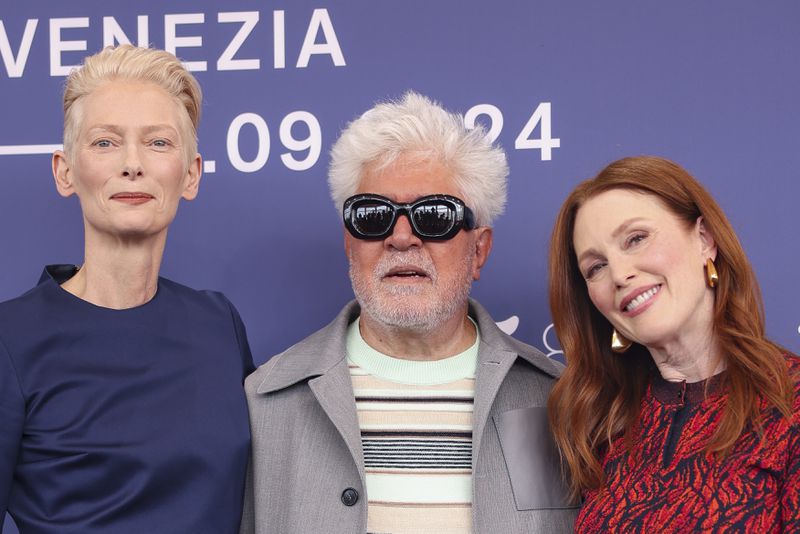 Tilda Swinton, from left, director Pedro Almodovar, and Julianne Moore pose for photographers at the photo call for the film 'The Room Next Door' during the 81st edition of the Venice Film Festival in Venice, Italy, on Monday, Sept. 2, 2024. (Photo by Vianney Le Caer/Invision/AP)