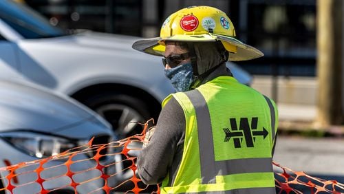 Archer Western’s Jesus Sanchez came dressed to absorb the sweat working outside along the road project on Hank Aaron Drive at Georgia Avenue in Atlanta on Friday, June 14, 2024. Saturday is forecast to be 97 degrees, and Sunday, Father’s Day will see 95 degrees. (John Spink/AJC)
