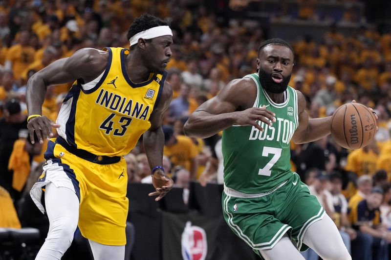 Boston Celtics guard Jaylen Brown (7) drives past Indiana Pacers forward Pascal Siakam (43) during the first half of Game 3 of the NBA Eastern Conference basketball finals, Saturday, May 25, 2024, in Indianapolis. (AP Photo/Michael Conroy)