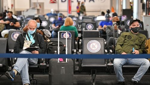 July 22, 2020 Atlanta - Social distancing signs are  displayed as Delta customers wait on Concourse A at Hartsfield-Jackson International Airport on Wednesday, July 22, 2020. (Hyosub Shin / Hyosub.Shin@ajc.com)