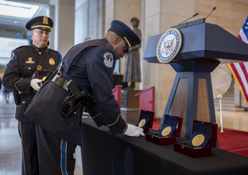 U.S. Capitol Police honor guards place Congressional Gold Medals to be presented at a ceremony to honor the Black women mathematicians of NASA who contributed to the space race and who were the subject of the movie "Hidden Figures," at the Capitol in Washington, Wednesday, Sept. 18, 2024. (AP Photo/J. Scott Applewhite)