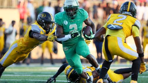 Buford running back Justin Baker (2) rushes for yardage during the first half against St. Frances Academy at Tom Riden Stadium, Friday, August 18, 2023, in Buford, Ga. (Jason Getz / Jason.Getz@ajc.com)