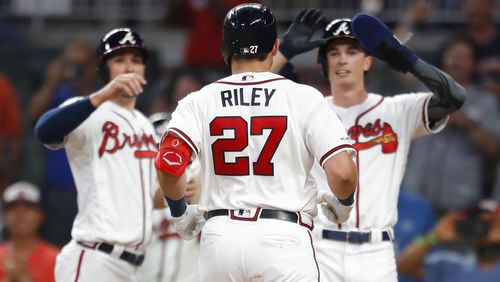 Austin Riley celebrates hitting a grand slam with teammates as he scores in the seventh inning of an MLB game against the Washington Nationals at SunTrust Park on May 29, 2019 in Atlanta, Georgia. (Photo by Todd Kirkland/Getty Images)