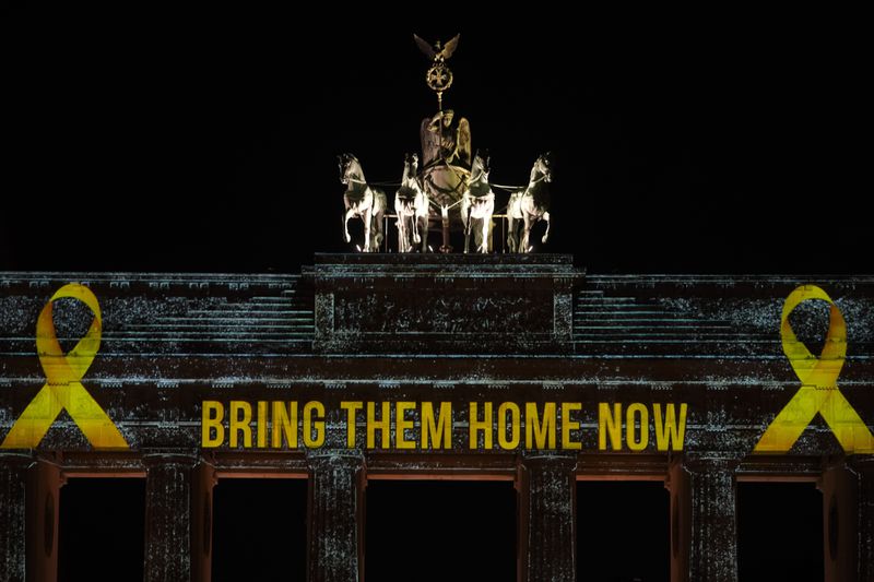 The Brandenburg Gate is illuminated in solidarity with Israel, marking the first anniversary of the Hamas spearheaded attacks on Israel, in Berlin, Germany, Monday, Oct. 7, 2024. (AP Photo/Markus Schreiber)