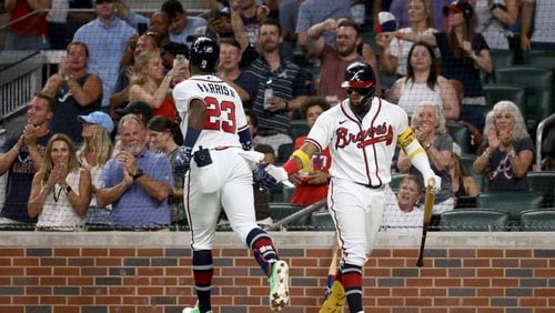 Braves center fielder Michael Harris (23) greets right fielder Ronald Acuna after Harris hit a solo home run during the seventh inning against the St. Louis Cardinals at Truist Park on Thursday, July 7, 2022, in Atlanta. The Cardinals won 3-2. (Jason Getz / Jason.Getz@ajc.com)