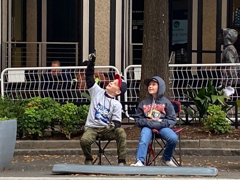 Friends Cooper Rose, 11, and Channing Pittman, 10, of Walton County, Georgia, prepare for Friday’s parade along Peachtree Street in Atlanta. The fifth graders skipped school to attend. VANESSA McCRAY/ AJC