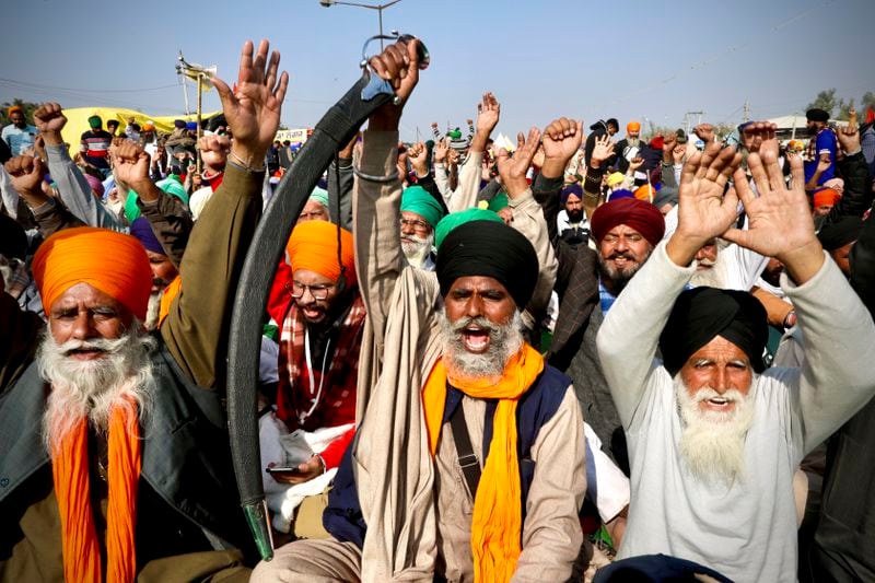 FILE- Protesting farmer leaders shout slogans as they sit on a day long hunger strike against contentious agriculture reforms at the Delhi- Haryana border, outskirts of New Delhi, Monday, Dec.14, 2020. Since coming to power a decade ago, Prime Minister Narendra Modi has been notorious for big, bold and often snap decisions, like the agricultural reforms, that he’s found easy to execute thanks to the brute majority he enjoyed in India's parliament. Now, Modi faces a style of governance he has little experience in, or desire for. (AP Photo/Manish Swarup)