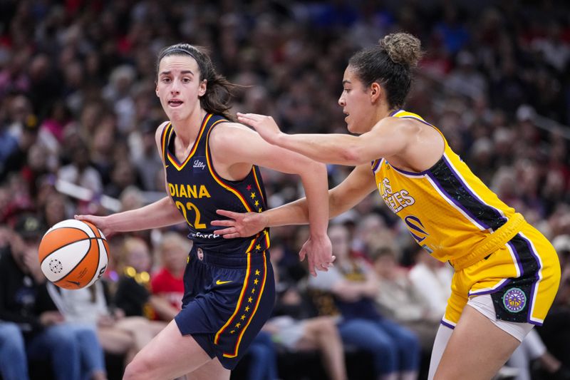 Indiana Fever guard Caitlin Clark (22) drives on Los Angeles Sparks guard Kia Nurse (10) in the second half of a WNBA basketball game in Indianapolis, Wednesday, Sept. 4, 2024. (AP Photo/Michael Conroy)