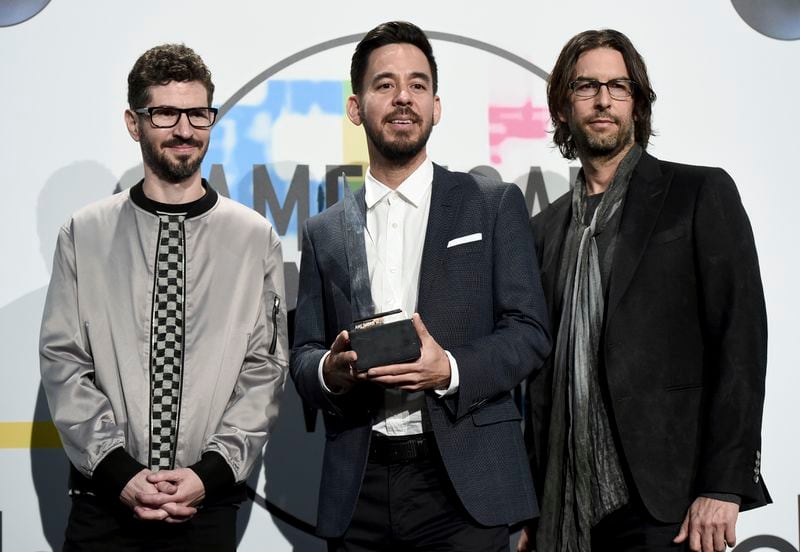 FILE - Brad Delson, from left, Mike Shinoda, and Rob Bourdon of Linkin Park pose in the press room with the award for favorite artist alternative rock at the American Music Awards on Nov. 19, 2017, in Los Angeles. (Photo by Jordan Strauss/Invision/AP, File)