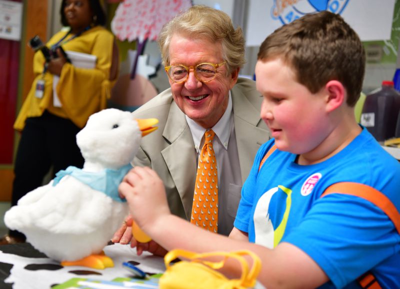 Aflac Chairman and CEO Dan Amos delivers a My Special Aflac Duck to Ethan Daniels of Alpharetta at the first “Duck Delivery” event, which was held at the Aflac Cancer and Blood Disorders Center at Children’s Healthcare of Atlanta during Childhood Cancer Awareness Month in 2018.