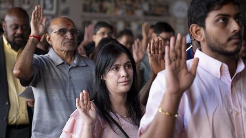 People take the oath of allegiance during a Naturalization ceremony at Jimmy Carter National Historic Park in Plains on Tuesday, Oct. 1, 2024. The ceremony was held in honor of President Carter’s 100th birthday.  Ben Gray for the Atlanta Journal-Constitution