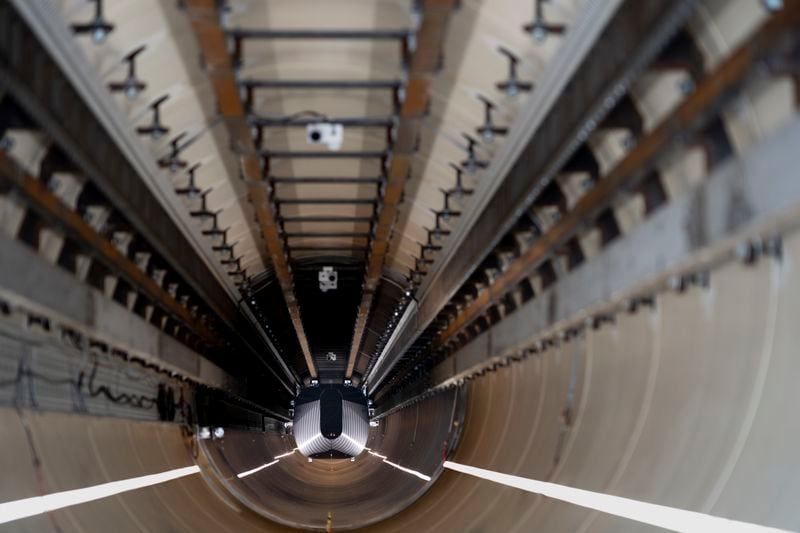 A test vehicle levitated by magnetic fields zips through a depressurized tube in a testing ground for a high-speed transit system during a press tour of a European test center for hyperloop transportation technology in Veendam, northern Netherlands, Friday, Sept. 6, 2024. (AP Photo/Peter Dejong)