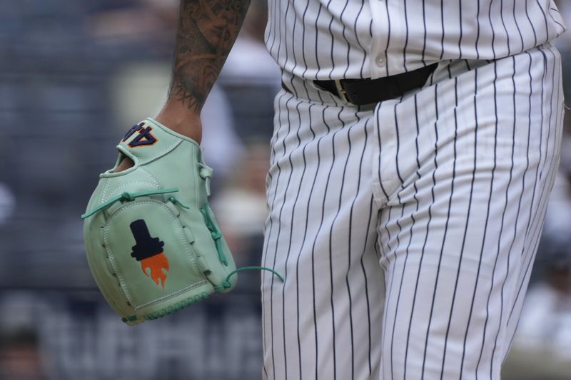 New York Yankees pitcher Nestor Cortes walks to the dugout with his decorated glove during the fourth inning of a baseball game against the Atlanta Braves, Sunday, June 23, 2024, in New York. (AP Photo/Pamela Smith)