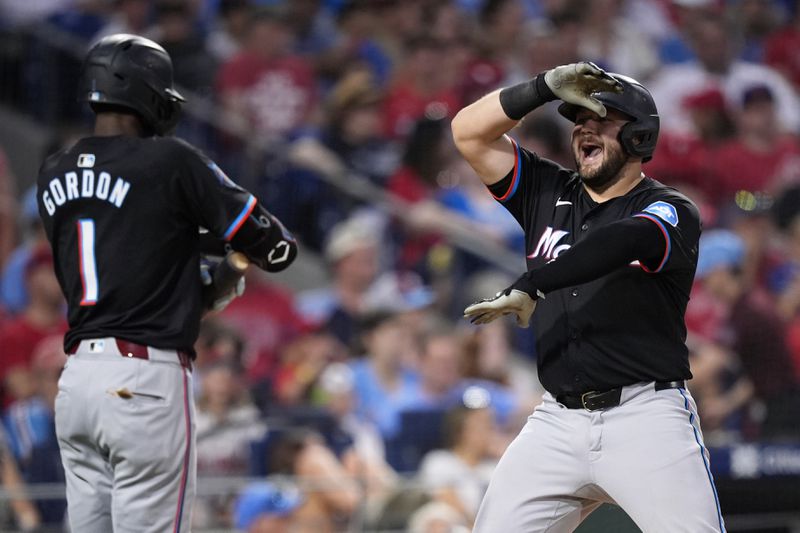 Miami Marlins' Jake Burger, right, celebrates with Nick Gordon after hitting a home run against Philadelphia Phillies pitcher Jeff Hoffman during the eighth inning of a baseball game, Thursday, June 27, 2024, in Philadelphia. (AP Photo/Matt Slocum)