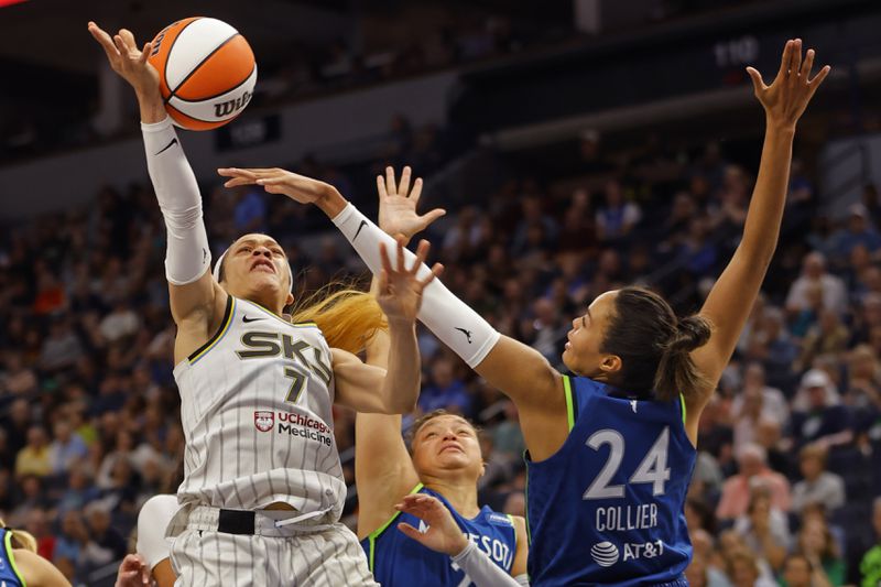 Chicago Sky guard Chennedy Carter (7) goes to the basket as Minnesota Lynx guard Kayla McBride, center, and forward Napheesa Collier (24) guard against her in the third quarter of a WNBA basketball game Friday, Sept. 13, 2024, in Minneapolis. (AP Photo/Bruce Kluckhohn)